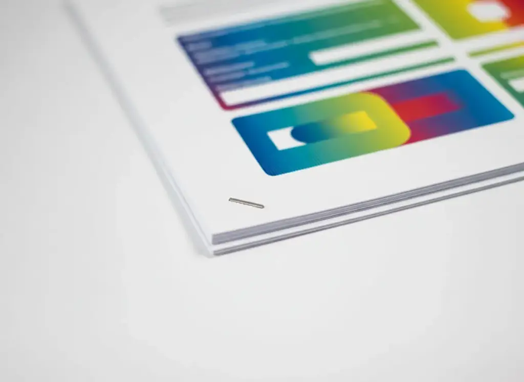 Stack of printed pages secured with a single corner staple