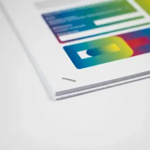 Stack of printed pages secured with a single corner staple